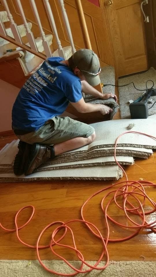 Aaron Van Alstine installing flooring on a residential staircase